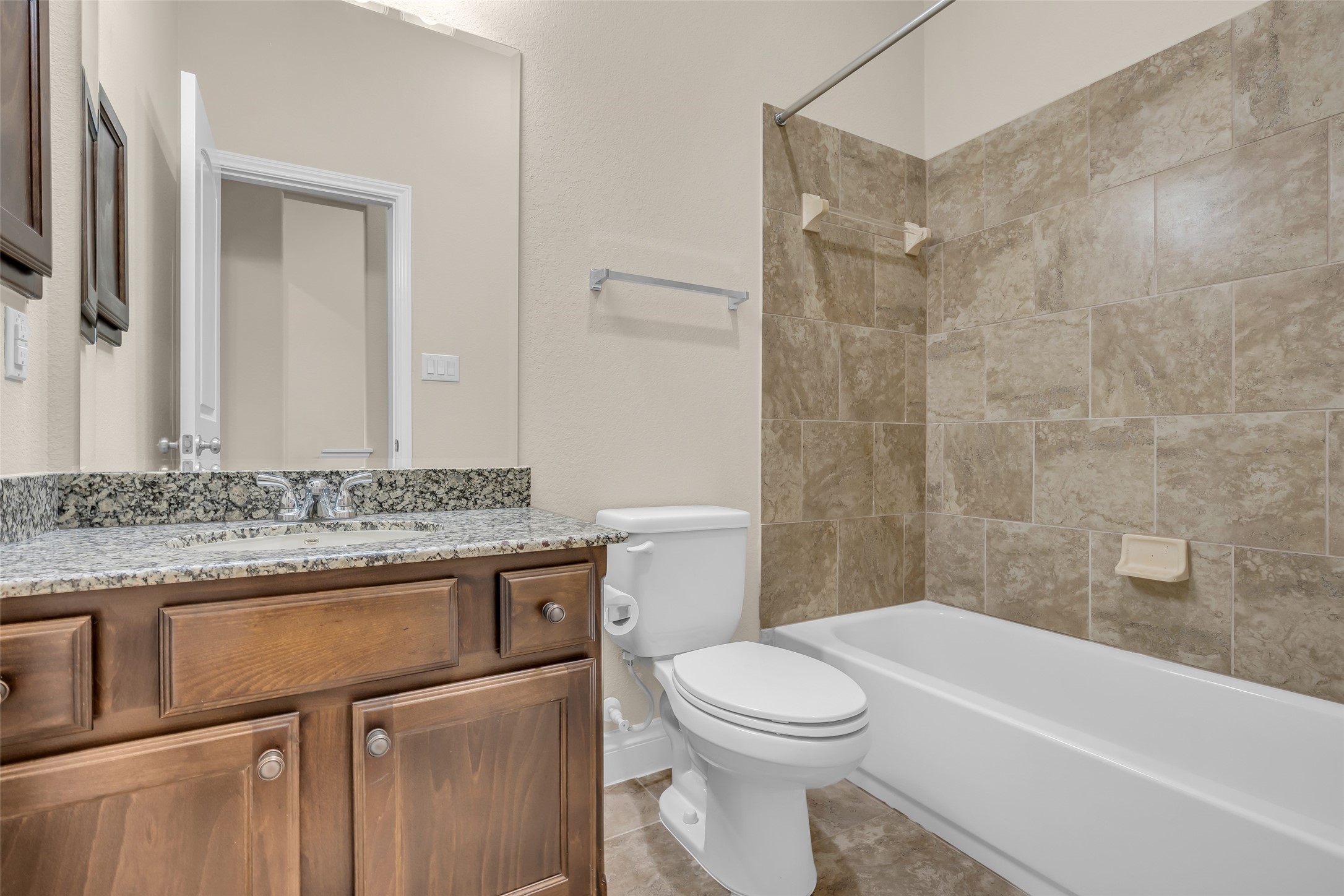6306 Fisher Bend Lane Rosenberg, TX 77471 - Photo 19 of 26 The common bathroom features a tub and shower combination, providing a practical and functional space for everyday use.