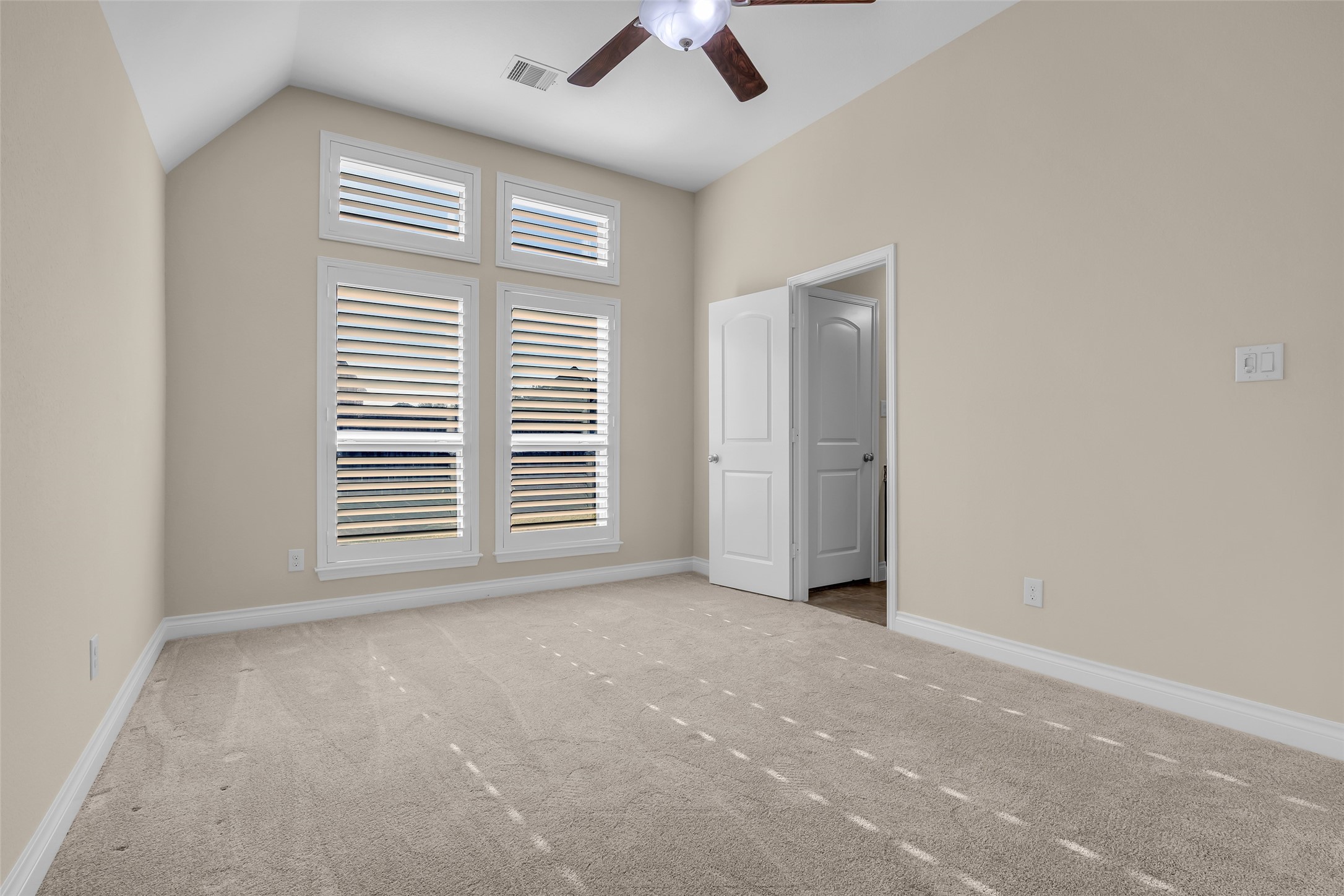 6306 Fisher Bend Lane Rosenberg, TX 77471 - Photo 20 of 26 This secondary bedroom at the back of the home features a couple of large windows that provide views of the backyard and fill the room with natural light. It also has an ensuite bath.