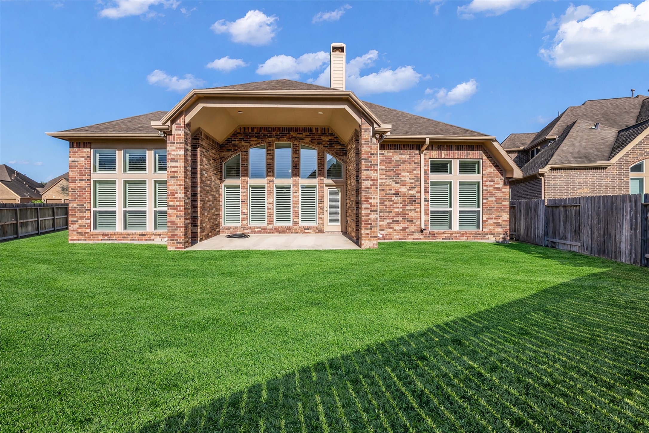6306 Fisher Bend Lane Rosenberg, TX 77471 - Photo 24 of 26 A full view of the back of the house highlights the brick exterior, giving the home a classic and timeless appearance.