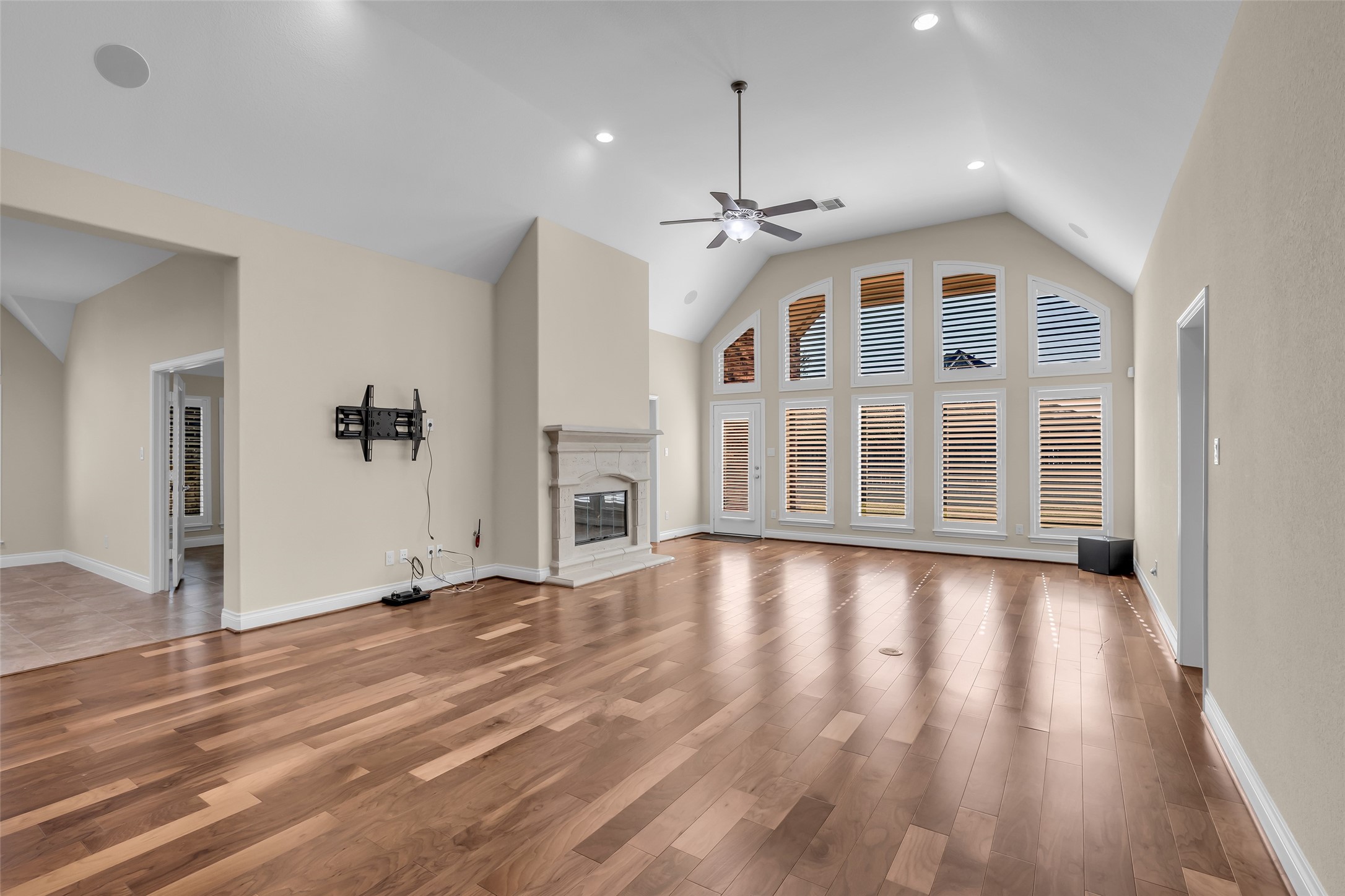 6306 Fisher Bend Lane Rosenberg, TX 77471 - Photo 5 of 26 The spacious family room features high ceilings and a gas fireplace, with large windows along one wall that fill the space with natural light and provide views of the backyard.