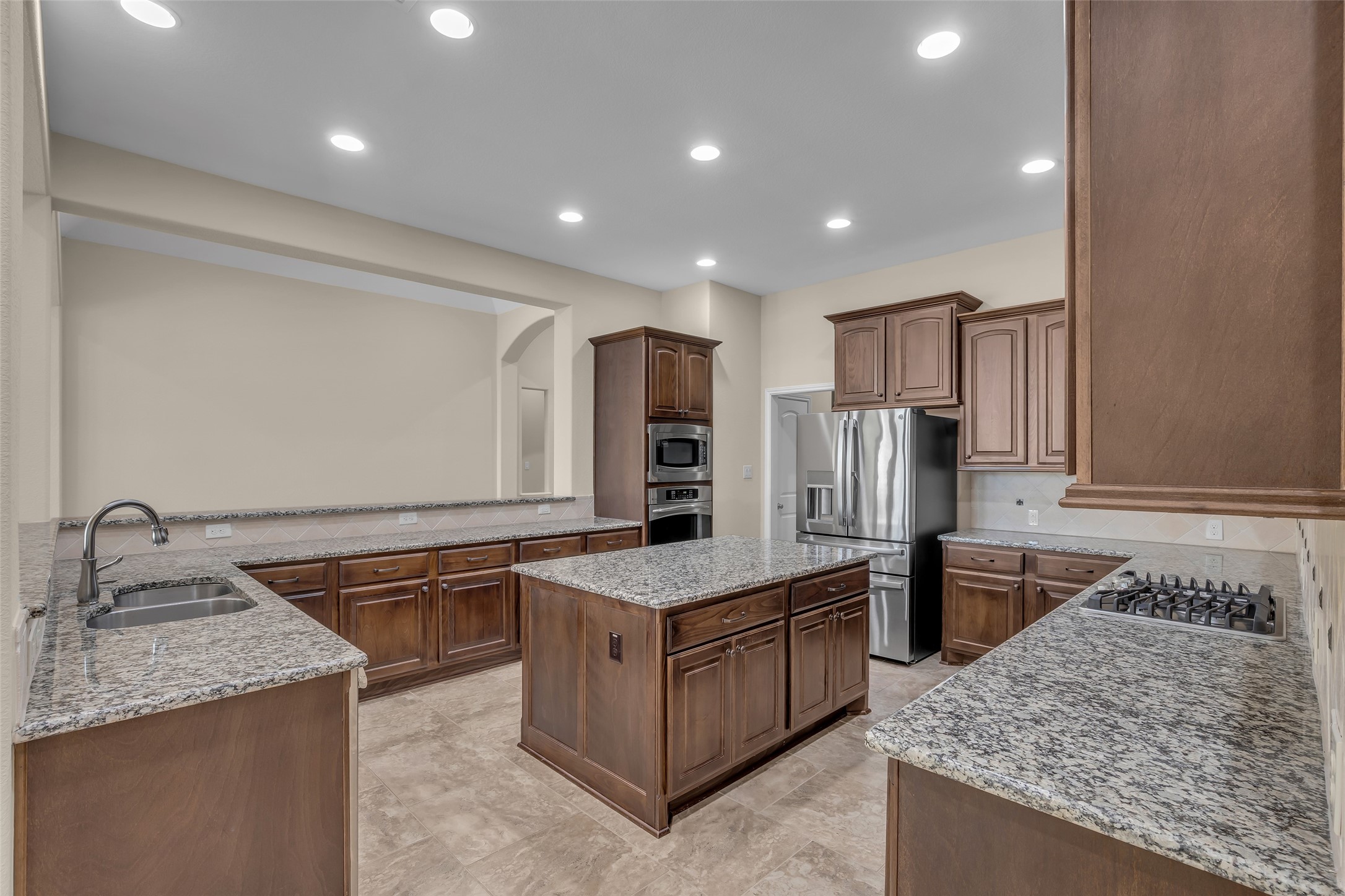 6306 Fisher Bend Lane Rosenberg, TX 77471 - Photo 10 of 26 The kitchen is equipped with a gas cooktop, microwave, single oven, dishwasher, refrigerator, and a garbage disposal for everyday convenience.