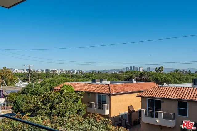 a view of a patio with table and chairs and potted plants