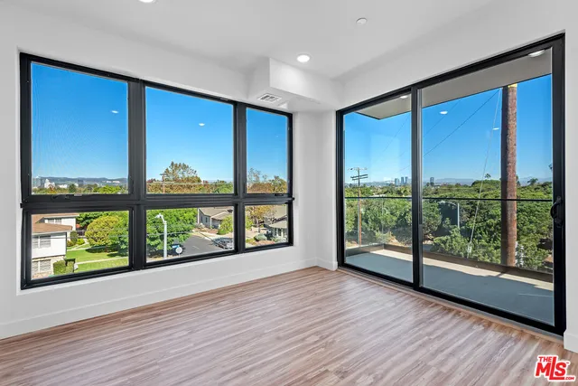 wooden floor in an empty room with a large window