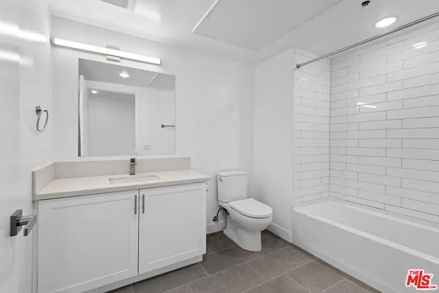 a bathroom with a toilet a sink and bathtub