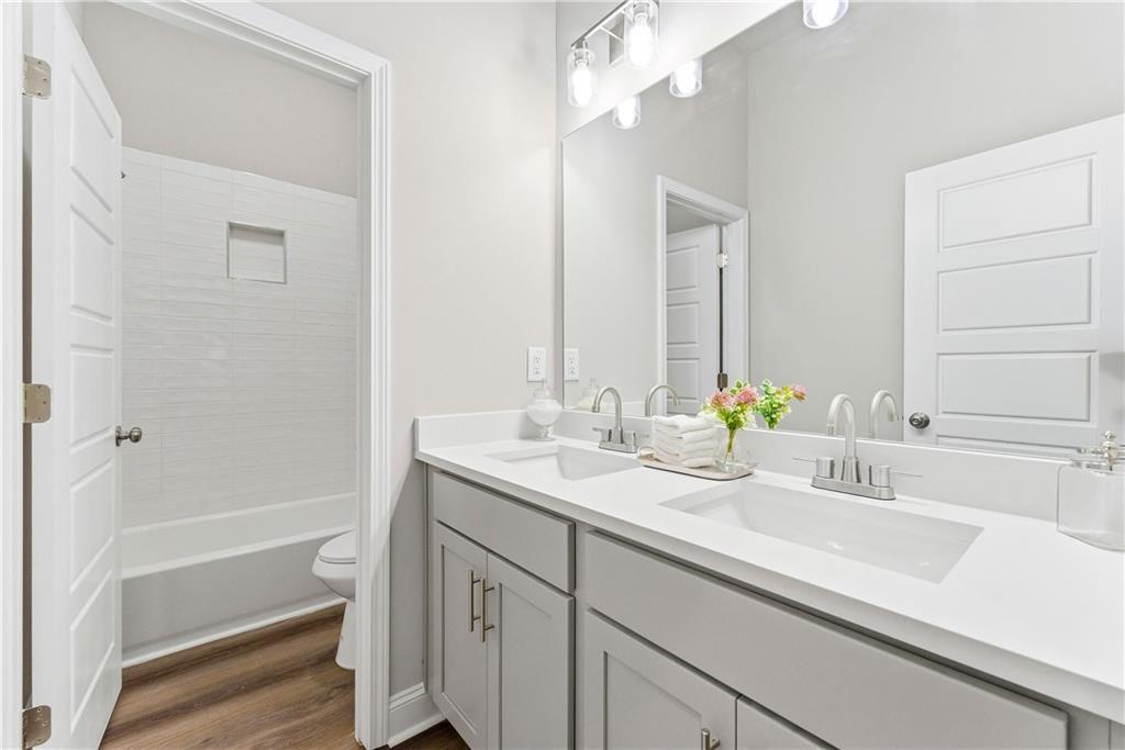 3360 Sarah Trail, Unit 1 Decatur, GA 30032 - Photo 23 of 41 a bathroom with a sink a mirror and a bathtub