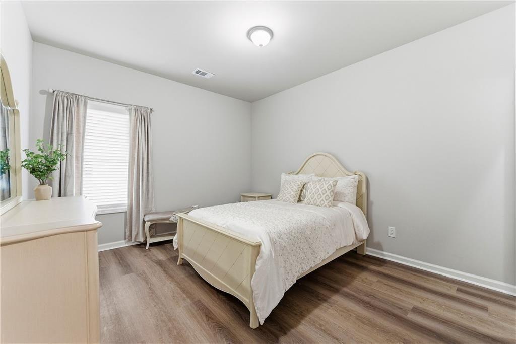 3360 Sarah Trail, Unit 1 Decatur, GA 30032 - Photo 29 of 41 a bed sitting in a spacious bedroom next to a window