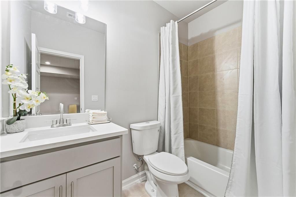 3360 Sarah Trail, Unit 1 Decatur, GA 30032 - Photo 31 of 41 a bathroom with a sink a toilet and shower