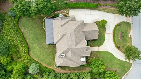 a kitchen with stainless steel appliances granite countertop a stove a sink dishwasher a dining table and chairs with wooden floor