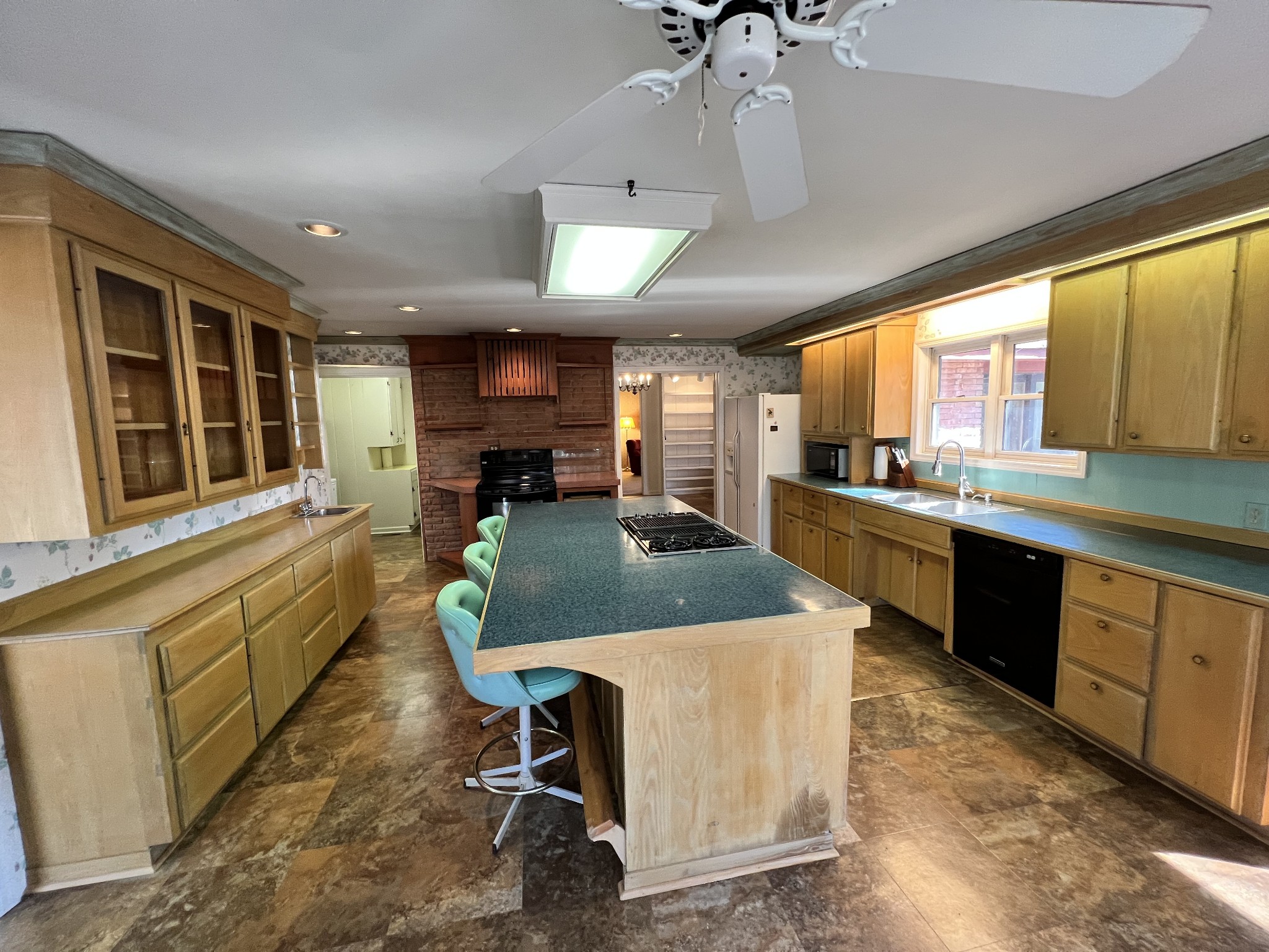499 Willow Oak Road Manchester, TN 37355 - Photo 8 of 26 a kitchen with stainless steel appliances granite countertop table chairs sink and cabinets