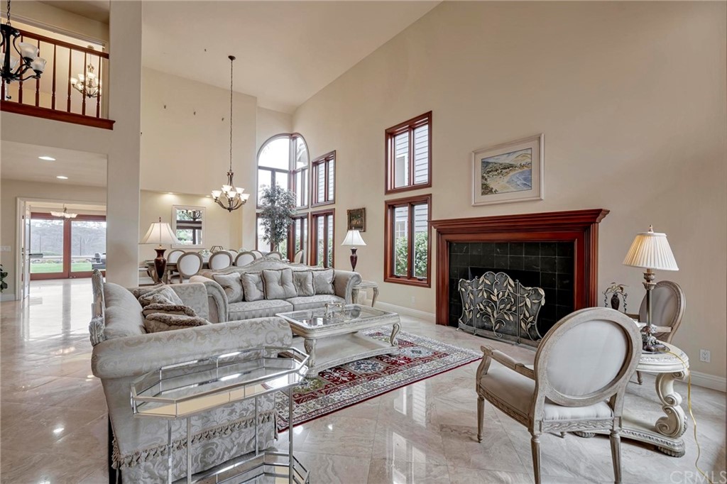 14 Camberley Laguna Niguel, CA 92677 - Photo 21 of 69 a living room with furniture a fireplace a rug and a window