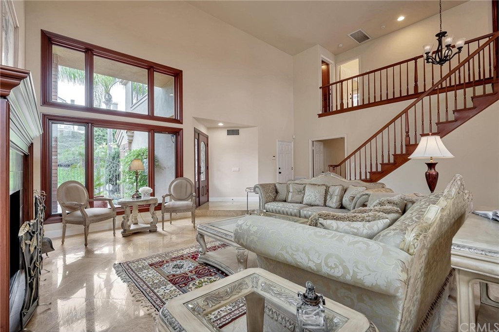 14 Camberley Laguna Niguel, CA 92677 - Photo 22 of 69 a living room with furniture stairs and a rug