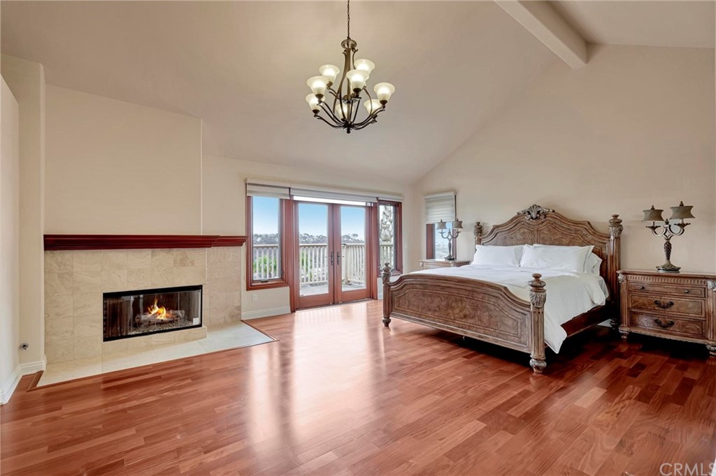 14 Camberley Laguna Niguel, CA 92677 - Photo 47 of 69 a spacious bedroom with a bed and a fireplace