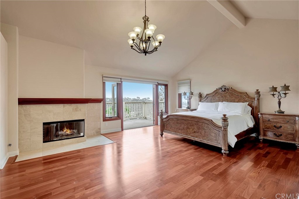14 Camberley Laguna Niguel, CA 92677 - Photo 48 of 69 a spacious bedroom with a bed and a fireplace