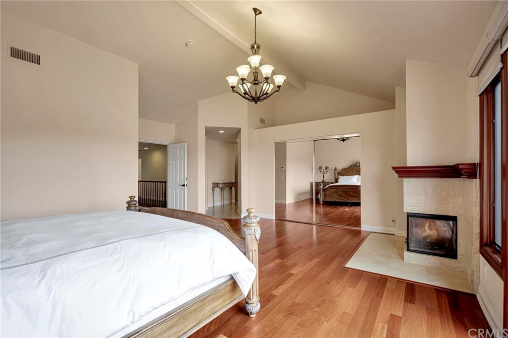 14 Camberley Laguna Niguel, CA 92677 - Photo 50 of 69 a spacious bedroom with a bed and wooden floor