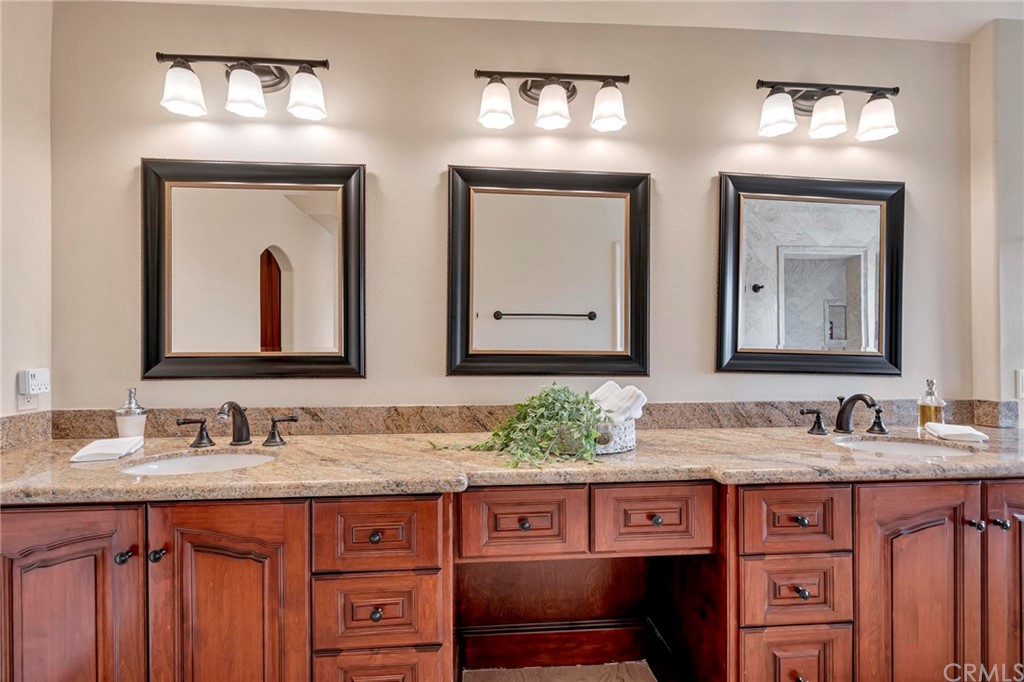 14 Camberley Laguna Niguel, CA 92677 - Photo 59 of 69 a bathroom with a granite countertop sink two mirror a and cabinets