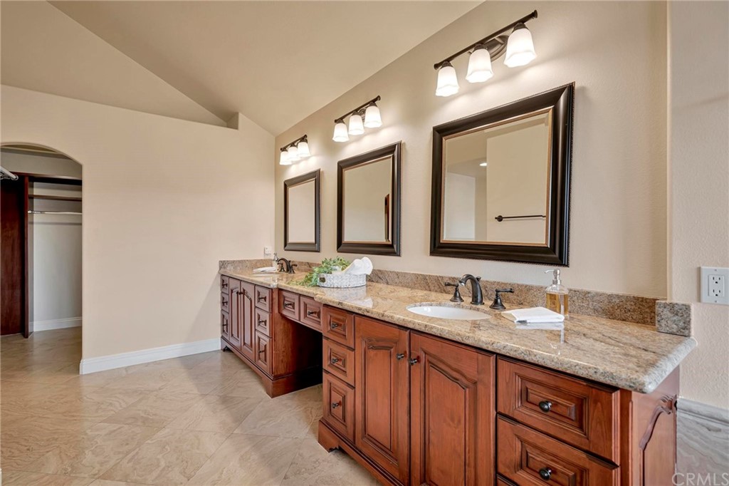 14 Camberley Laguna Niguel, CA 92677 - Photo 60 of 69 a bathroom with a granite countertop double vanity sink and a mirror
