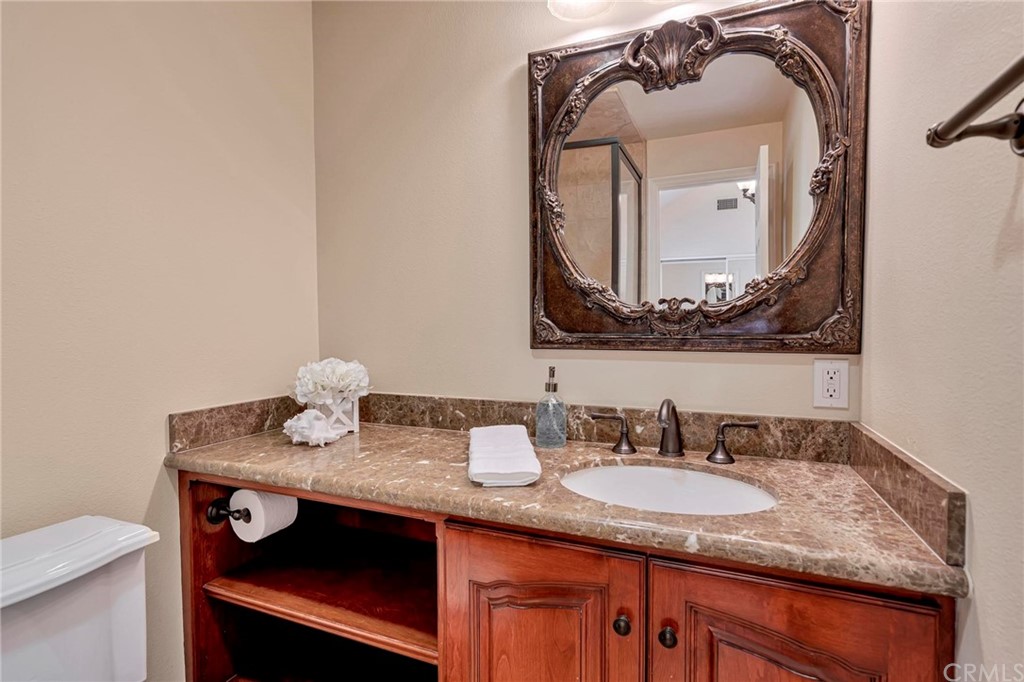 14 Camberley Laguna Niguel, CA 92677 - Photo 66 of 69 a bathroom with a granite countertop sink and a mirror