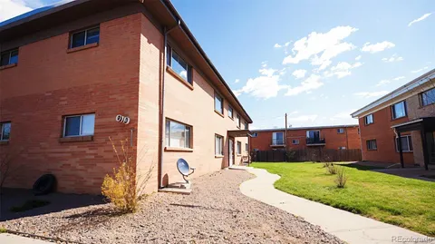 a view of a house with a yard and sitting area