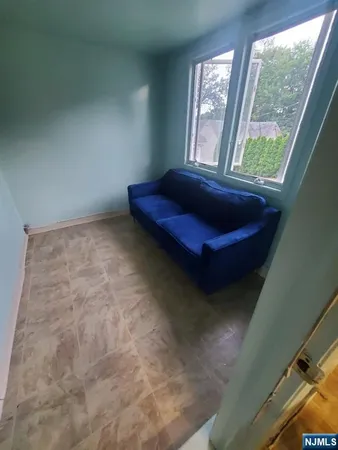 a room with a bed and windows