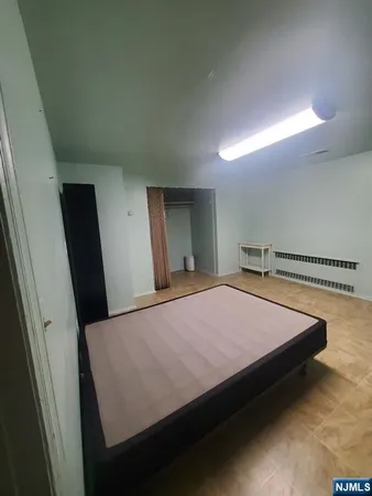 a bed sitting in a bedroom and bathroom