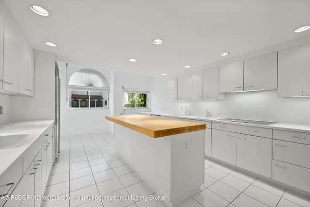 a kitchen with granite countertop a sink and cabinets