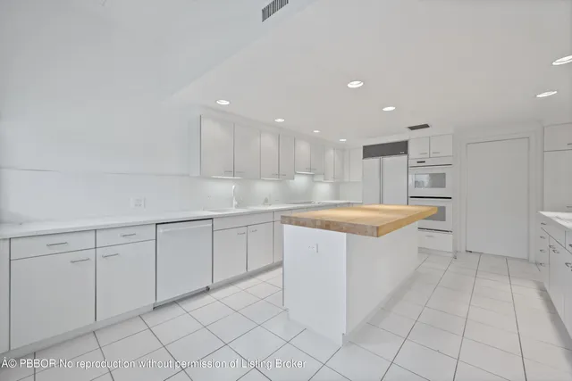a large kitchen with white cabinets