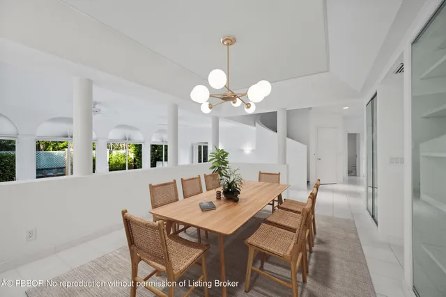 a view of a dining room with a table and chairs