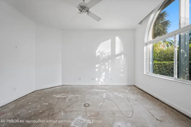 an empty room with a empty space and windows