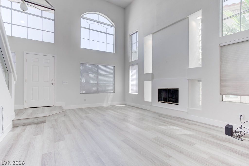 1 Rising Sun Court Henderson, NV 89074 - Photo 4 of 47 A striking fireplace wall and lofty ceilings define this spacious living area.