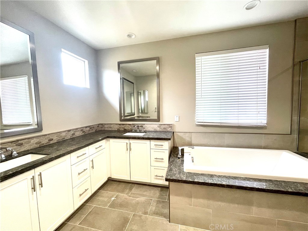 155 Blue Crystal Drive Walnut, CA 91789 - Photo 7 of 10 a bathroom with a granite countertop tub sink and mirror