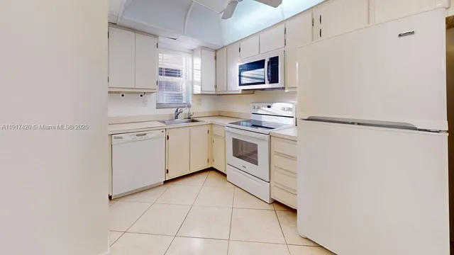 a kitchen with a sink appliances and cabinets