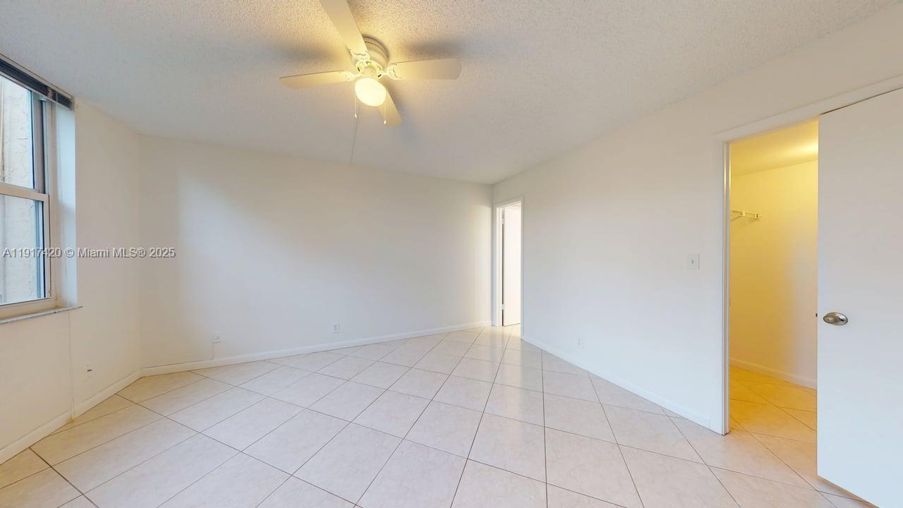 3300 West Rolling Hills Circle, Unit 302 Davie, FL 33328 - Photo 4 of 9 a view of an empty room with a window