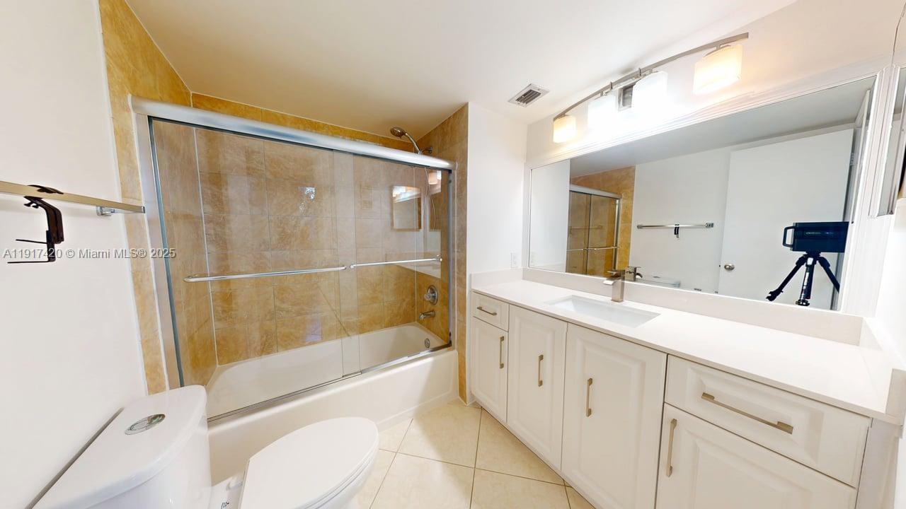 3300 West Rolling Hills Circle, Unit 302 Davie, FL 33328 - Photo 6 of 9 a bathroom with a sink a toilet and shower