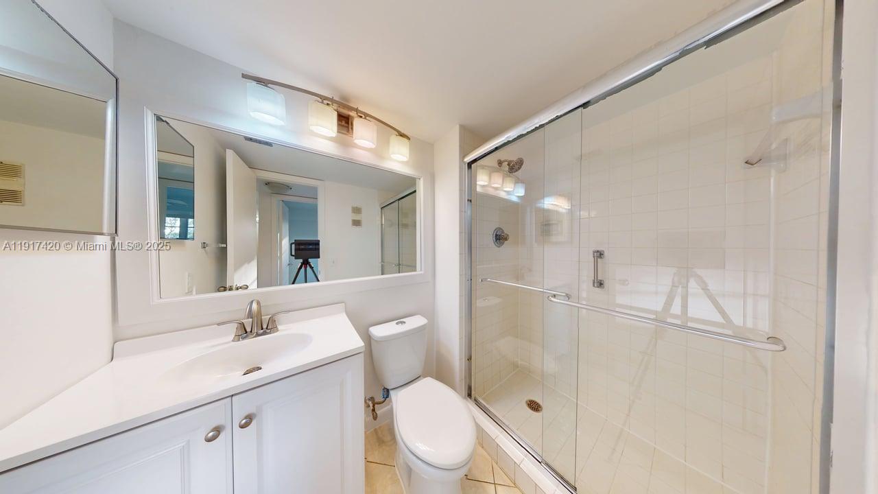 3300 West Rolling Hills Circle, Unit 302 Davie, FL 33328 - Photo 9 of 9 a bathroom with a toilet a sink and mirror