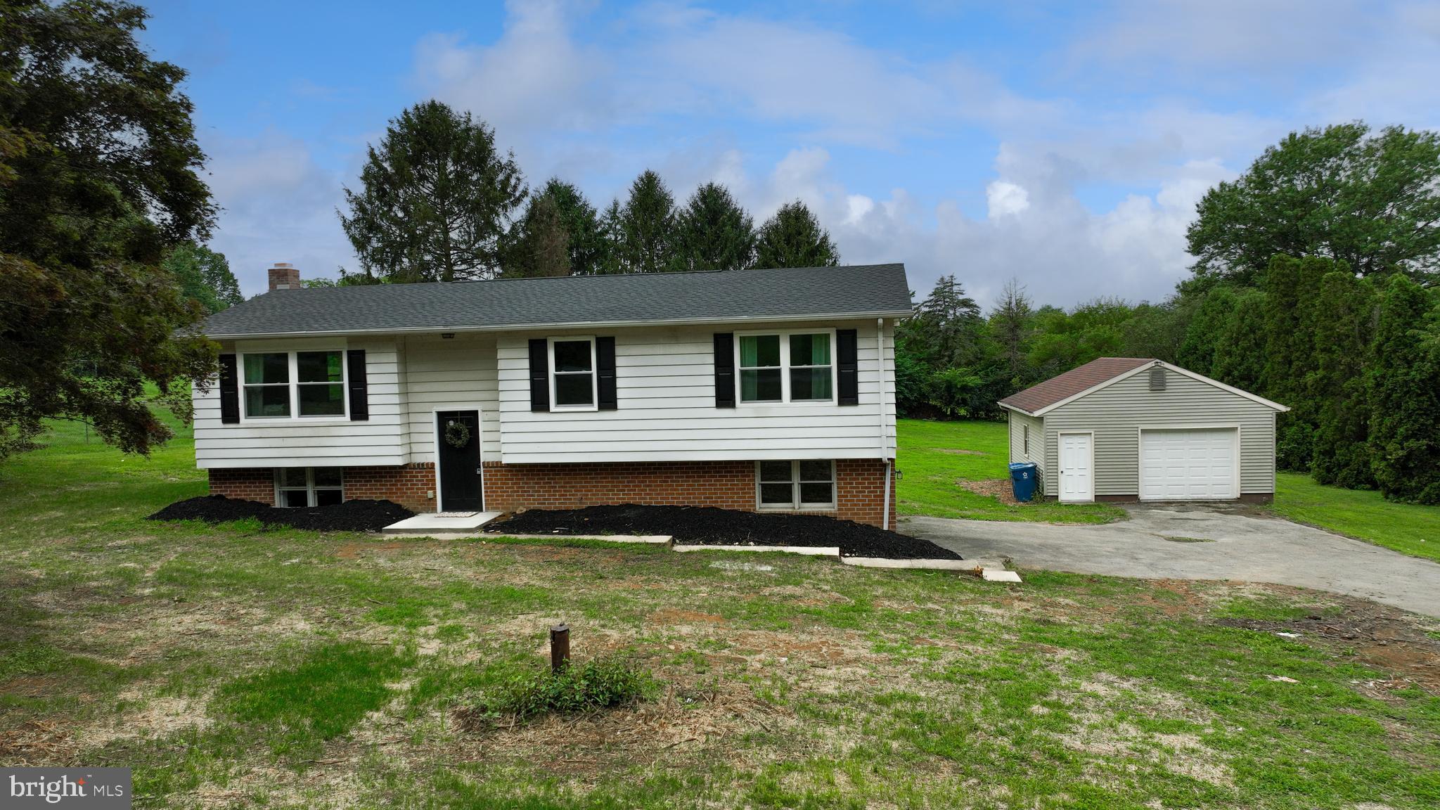 a view of a house with a yard porch and sitting area