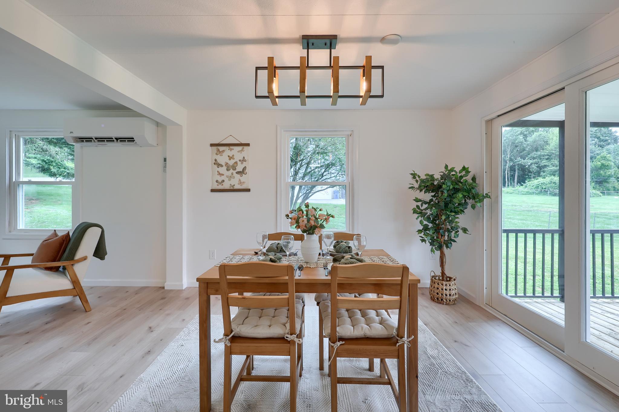 2208 Keeney Road Spring Grove, PA 17362 - Photo 16 of 64 a dining room with furniture a floor to ceiling window and wooden floor