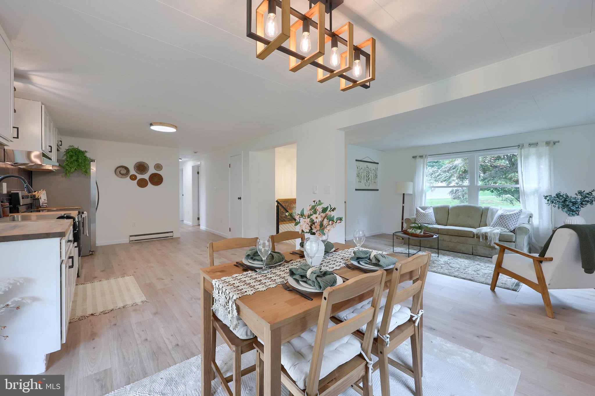 2208 Keeney Road Spring Grove, PA 17362 - Photo 18 of 64 a view of a dining room with furniture a chandelier and wooden floor