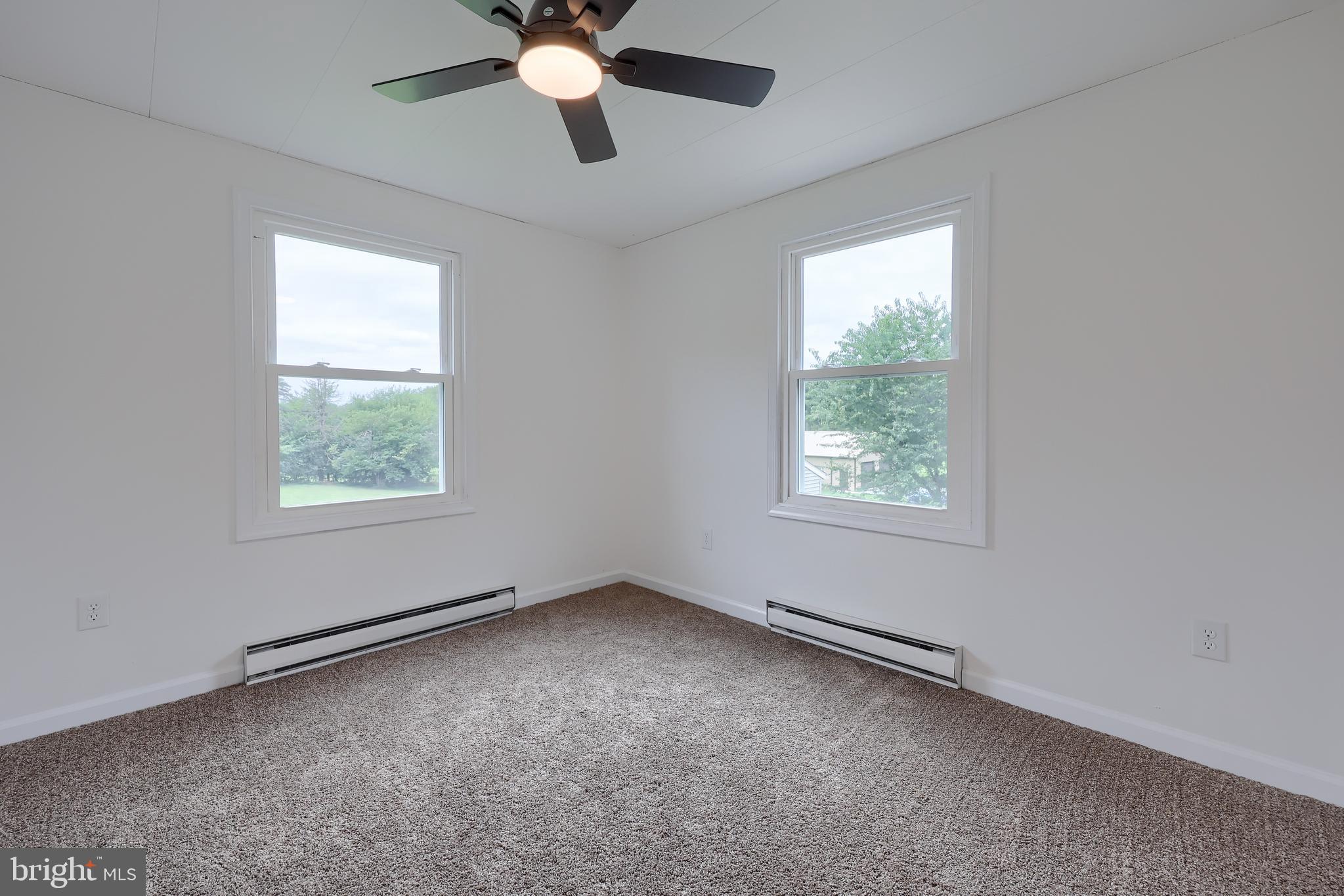 2208 Keeney Road Spring Grove, PA 17362 - Photo 33 of 64 an empty room with a window and a fan
