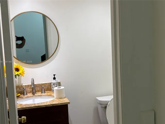 a bathroom with a toilet and a mirror