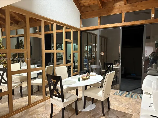 a view of a dining room with furniture and window