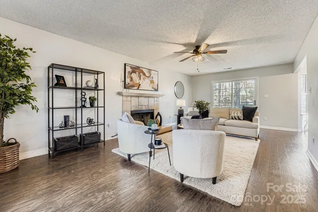 a living room with furniture a fireplace and a potted plant