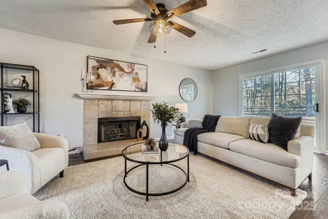 a living room with furniture and a fireplace