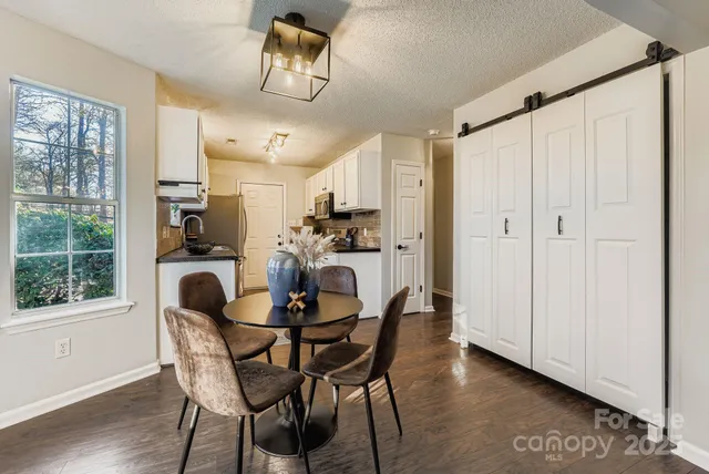 a dining room with furniture and window