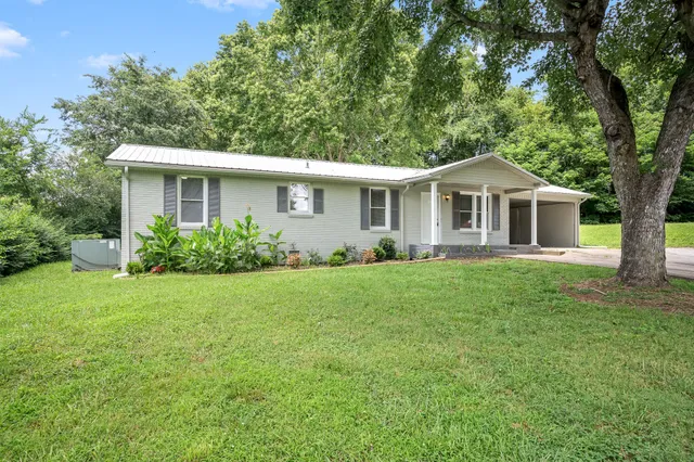 a front view of house with yard and green space