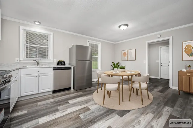 a kitchen with white cabinets and stainless steel appliances