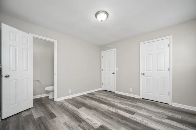 a view of a room with wooden floor and window