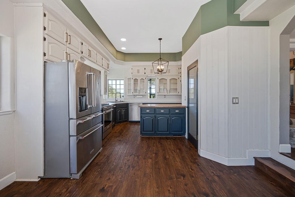 3154 Twin K Road Pilot Hill, CA 95664 - Photo 36 of 89 a kitchen with stainless steel appliances a refrigerator a sink cabinets and wooden floor