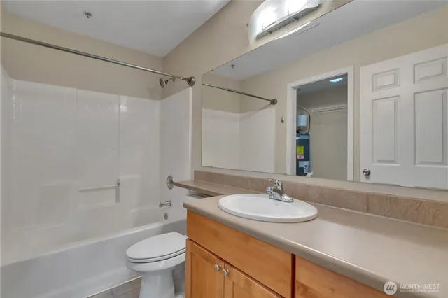 a bathroom with a sink toilet a mirror and shower