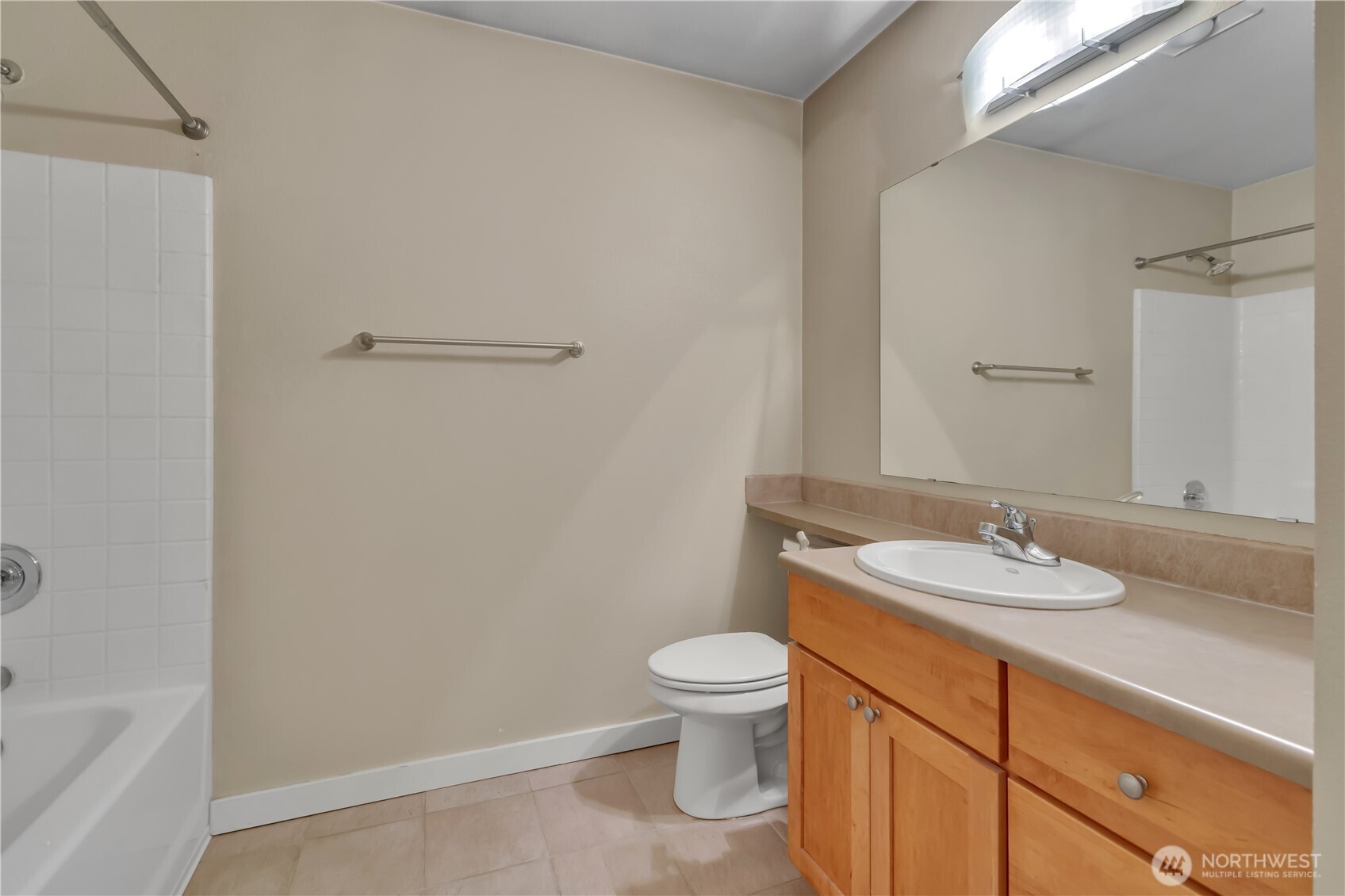 18930 Bothell Everett Highway, Unit B304 Bothell, WA 98012 - Photo 21 of 35 a bathroom with a granite countertop sink a toilet and a bathtub