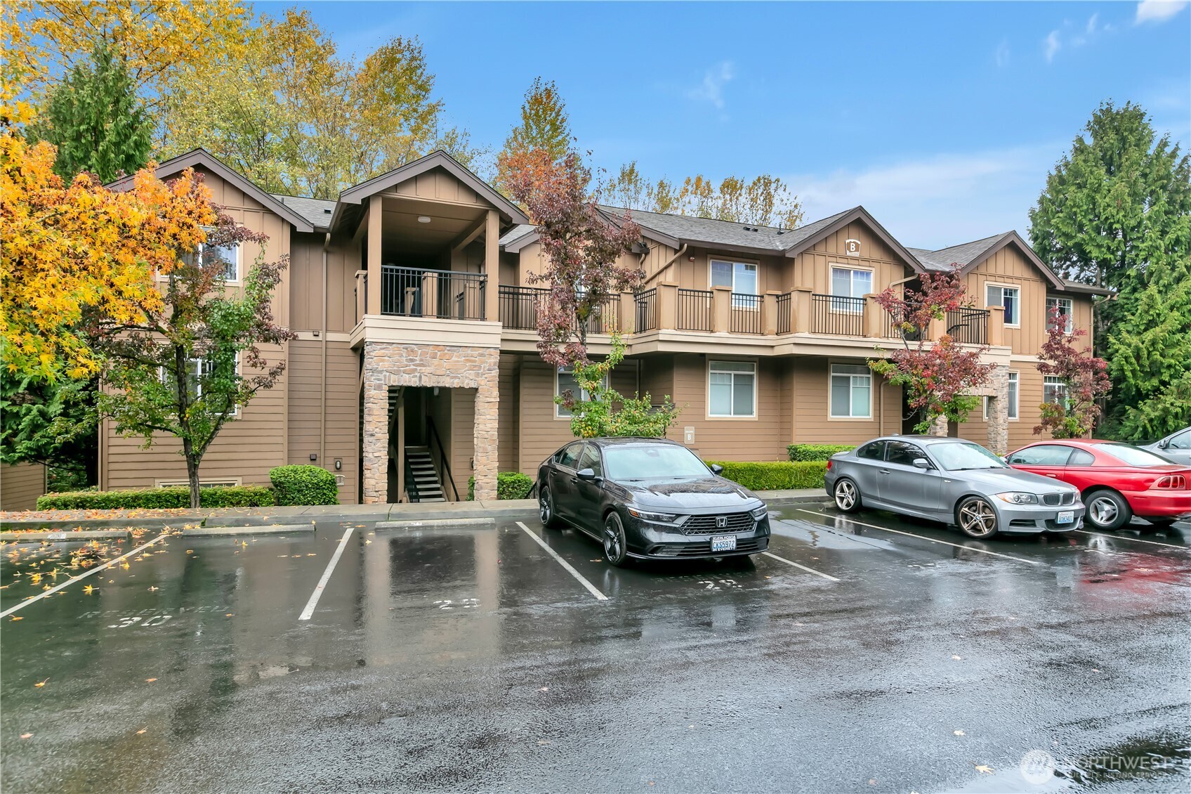18930 Bothell Everett Highway, Unit B304 Bothell, WA 98012 - Photo 25 of 35 a front view of a house with parking space